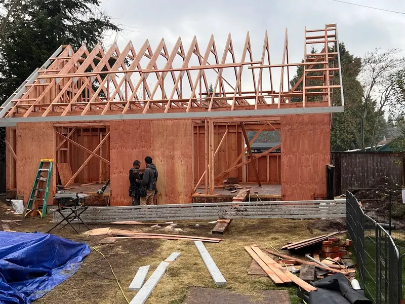 Roof trusses being set on a two-story ADU or home addition in Eugene, Oregon, showing the framing stage by Red Umbrella.