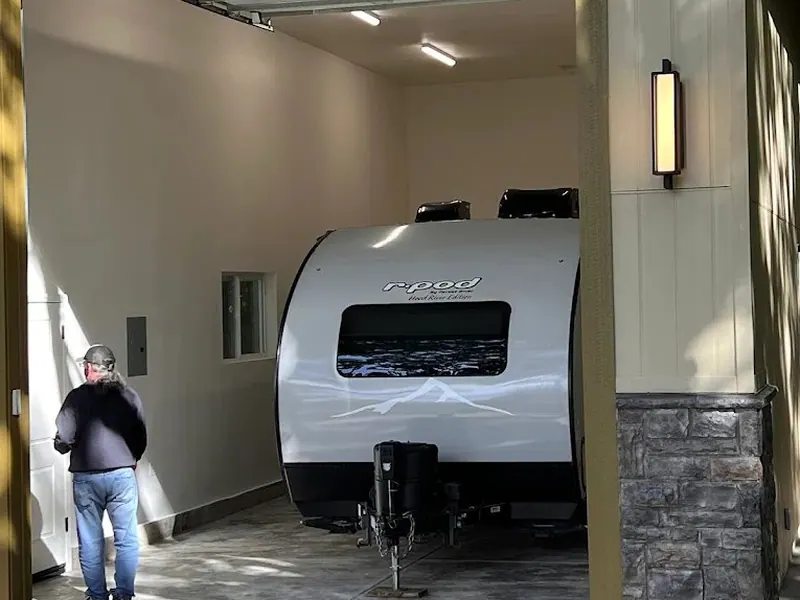 Finished interior of a custom detached RV garage with tall clear height and LED lighting, built by Red Umbrella in Eugene, Oregon.